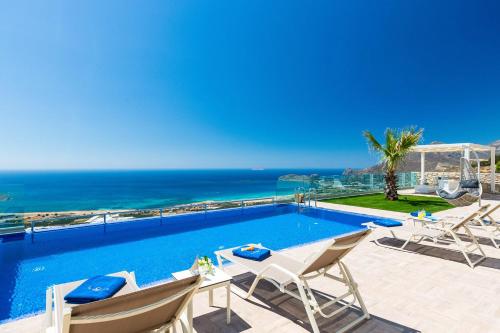 a swimming pool with a view of the ocean at Blue Horizon Luxury Villas in Falasarna