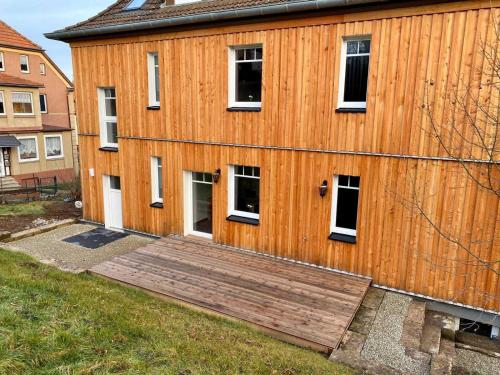 a wooden building with a wooden ramp in front of it at FeWoWa _ FerienWohnungen Walter in Bad Sachsa