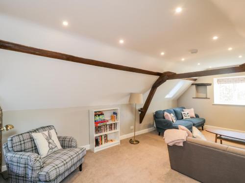 a living room with two chairs and a couch at Dovecote in Pickering