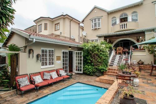 a house with a pool in front of it at Acorn B&B in Durban in Durban
