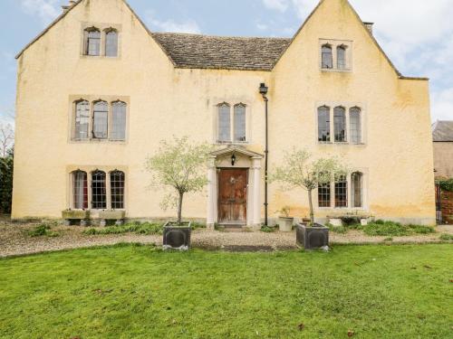 a large brick house with two entrances to a yard at Chapel House in Stonehouse