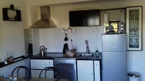 a kitchen with a sink and a refrigerator at Apartment Luz & Luna in Villajoyosa