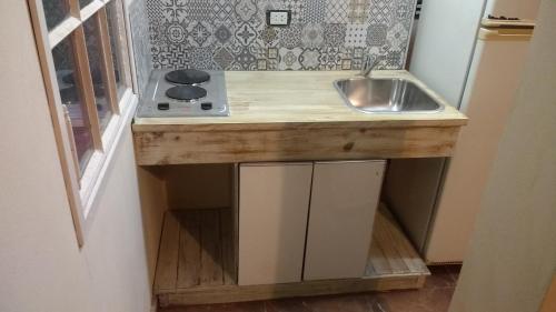 a small kitchen with a sink and a counter at apartamento VINTAGE IVA in Merlo