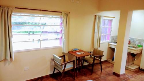 a dining room with a table and a window at apartamento VINTAGE IVA in Merlo