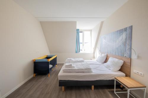 a bedroom with a bed and a chair in it at Villa Zeezicht in Noordwijk
