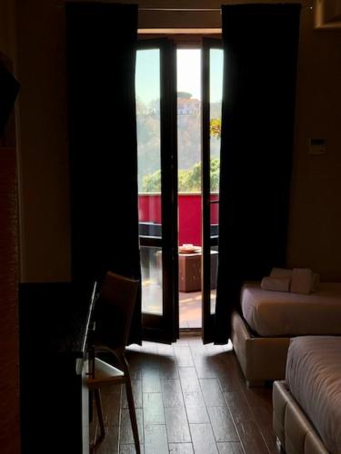 a room with a room with a bed and a window at Hotel Eremo in Soriano nel Cimino