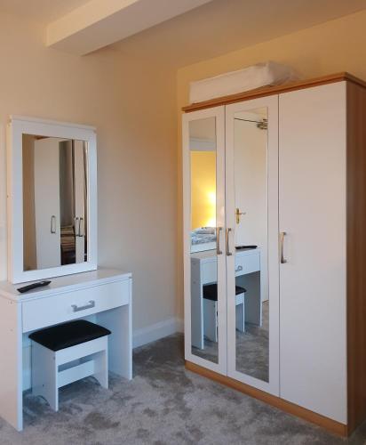 a bathroom with a vanity and a mirror at The Bowers Bar & Restaurant in Ballinrobe