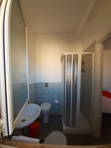 a bathroom with a toilet and a shower and a sink at Le Quattro Isole in Marsala