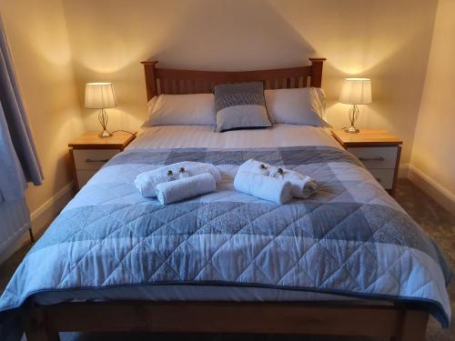 a bedroom with a bed with two towels on it at The Bowers Bar & Restaurant in Ballinrobe