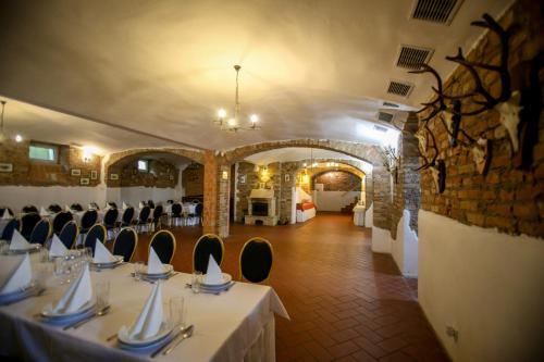 a dining room with tables and chairs in a building at Dwór Strzyżew in Żelazowa Wola