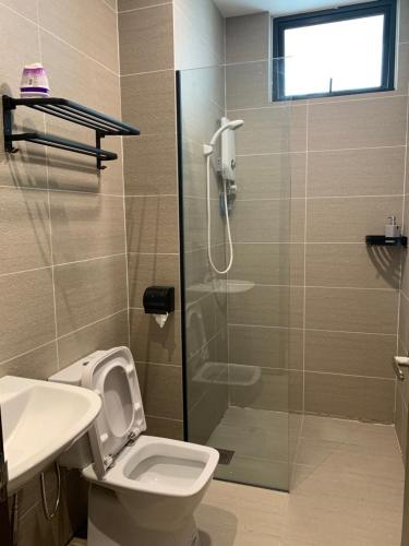 a bathroom with a shower and a toilet and a sink at 3Bedroom Rex Apartment 5min Drive to Vivacity in Kuching