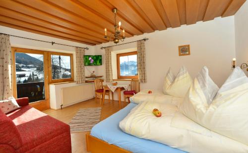 a living room with a bed and a couch at Gapphof in Reith bei Seefeld
