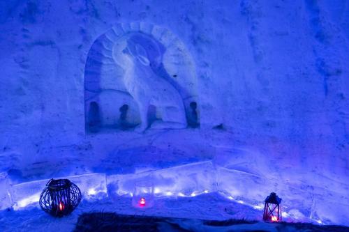 an ice room with a statue of a bird and lights at Lucky Ranch Snow Igloos in Pyhätunturi