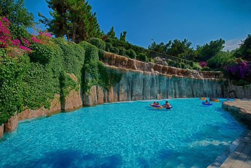 a group of people rafting down a river at Utopia World in Mahmutlar