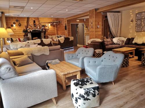 a living room with couches and chairs and a table at Domaine de l'Adoux in Saint-Jean Montclar