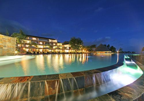 a large pool of water in front of a large building at Te Moana Tahiti Resort in Punaauia