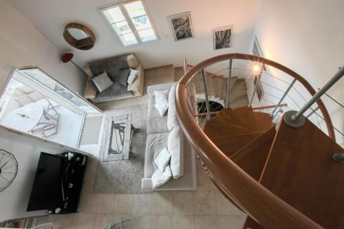 an overhead view of a spiral staircase in a house at CAPO BIANCO - Cap Corse et Vue Mer in Ersa