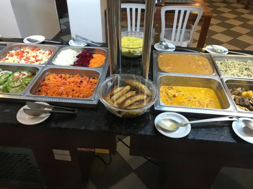 a buffet with many different types of food on a table at Hotel Enseada de Ponta Negra in Natal