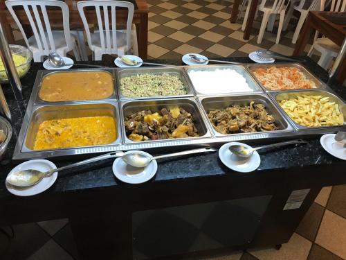 a buffet of different types of food on a table at Hotel Enseada de Ponta Negra in Natal
