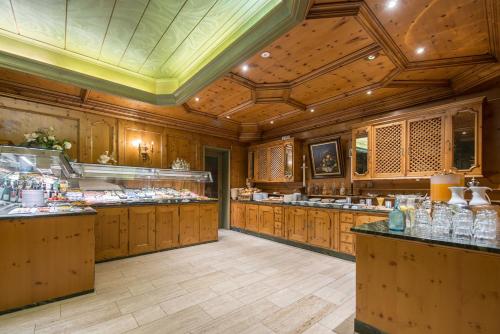 a large kitchen with wooden cabinets and counters at Hotel Dreiflüssehof in Passau