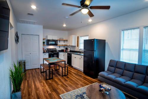 a kitchen and living room with a couch and a table at Downtown View Cozy 2BR1BA Home Sleeps 8 in San Antonio