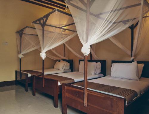 Кровать или кровати в номере Amaan Nungwi Hotel