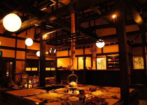a room with a table and lights in a building at Hidaji (Adult Only) in Takayama