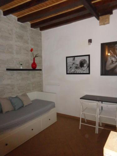 a room with a bed and a table in it at Casa Gaia Ortigia Holiday Home in Syracuse
