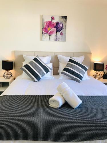 a bedroom with two beds with pillows on them at Melbourne Inner City Holiday Home Near CBD & Flemington in Melbourne