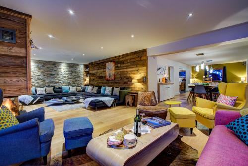 a living room with couches and chairs at Chalet Rubicon in Les Houches