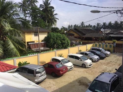 a row of cars parked in a parking lot at Maena Water Chalets in Tumpat