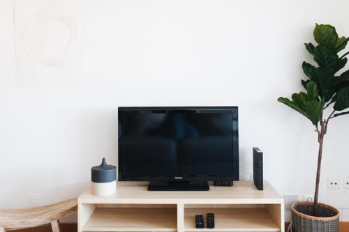 a flat screen tv sitting on top of a tv stand at VIVA Cozy Panoramic Flat in Senhora da Hora