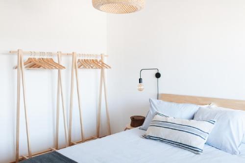 a bedroom with a bed with blue and white pillows at Cozy Panoramic Apartment near Metro Station in Senhora da Hora