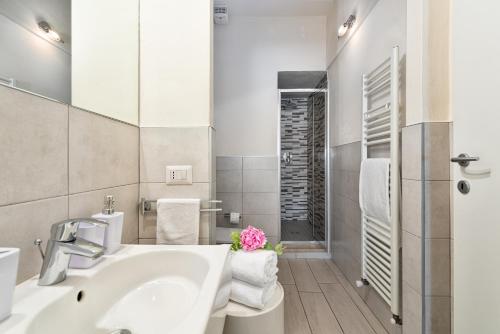 a white bathroom with a sink and a shower at Windows On Florence in Florence