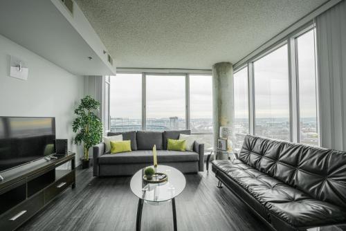 a living room with a couch and a table at Heaven On Baltimore Downtown Fully Furnished Apartments in Baltimore