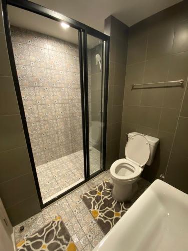 a bathroom with a shower and a toilet and a tub at La casita Hua-Hin seaview by Yaya in Hua Hin