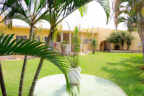 a courtyard with palm trees and a building at Recanto Serenissima in São Pedro