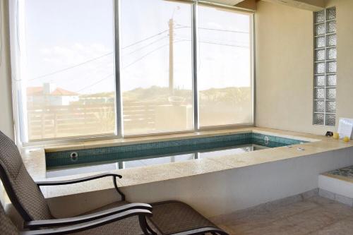 a swimming pool in a room with a window at Namaste casas de mar in Villa Gesell