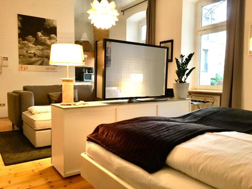 a bedroom with a large computer monitor on a desk at Berlin Style Apartments - Schönholzer Straße in Berlin