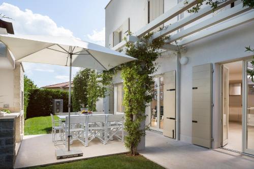 a patio with a table and an umbrella at Villa Petra by HMZ Villas in Vabriga