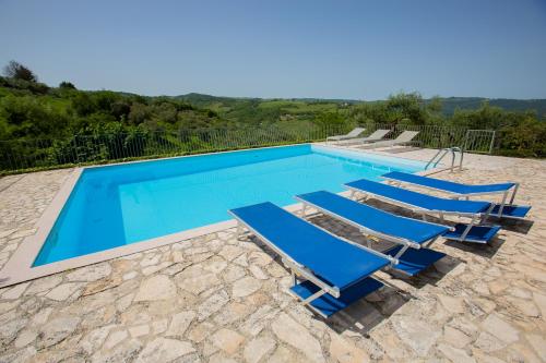 a swimming pool with lounge chairs and a swimming pool at Oleandro 1 in Ripabottoni