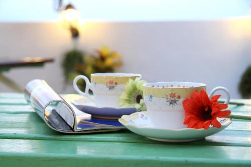 two cups and saucers sitting on a table at Winter's Love in Wujie