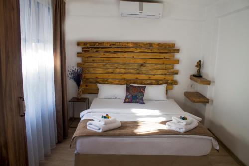a bedroom with a bed with two towels on it at Lavinia Otel in Cesme
