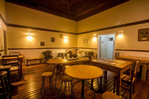 a restaurant with tables and stools in a room at Villa Don in Petrópolis