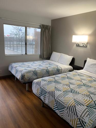 a hotel room with two beds and a window at Motel 6-Dayton, OH in Dayton
