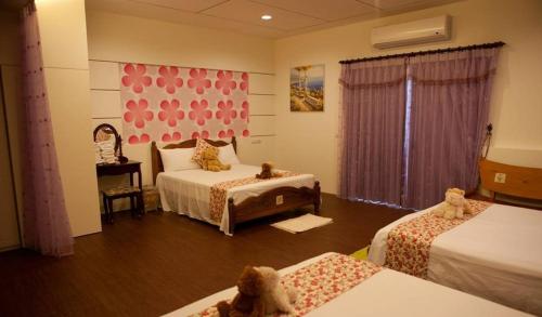 a bedroom with two beds and a table with a mirror at Winter's Love in Wujie