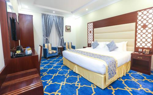 a hotel room with a large bed and a television at Jeddah Oasis Hotel in Jeddah