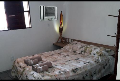 a bedroom with a bed and a air conditioner at Casa na Ilha da Croa in Barra de Santo Antônio
