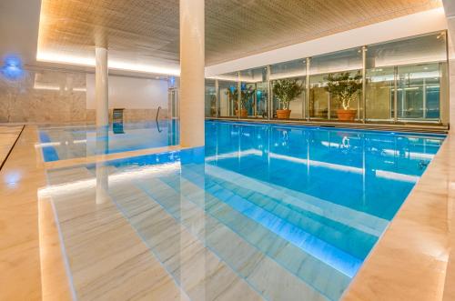 a large swimming pool with blue water at Praia do Sal Resort in Alcochete