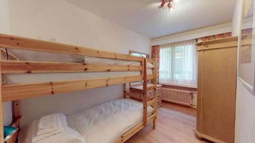 a bedroom with two bunk beds and a window at Abitaziun Paravicini 4 - St. Moritz in St. Moritz